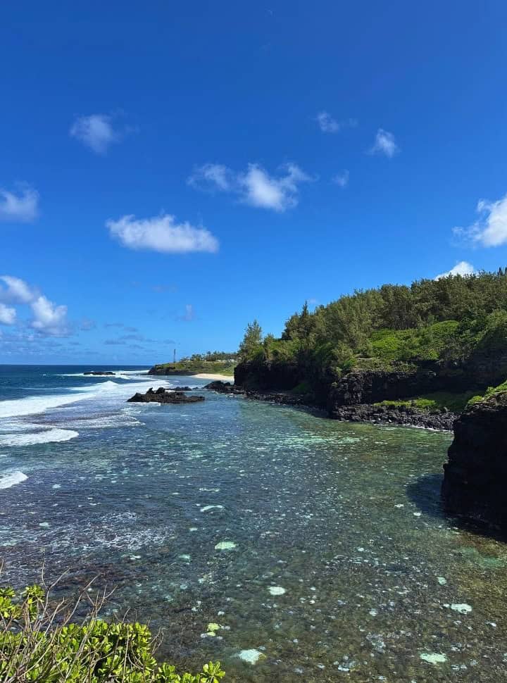 view from the cliffs of the clear ocean, rocks and headlands and beach in the distance in Mauritius