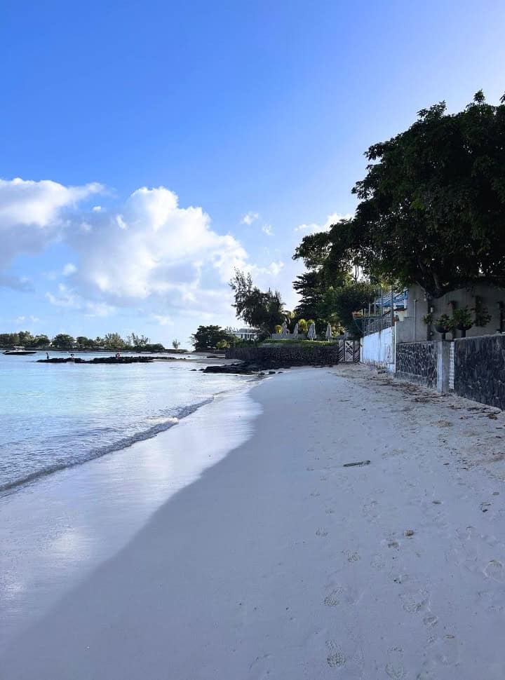 a quiet patch of beach at Pereybere, where houses are built along the beach itself
