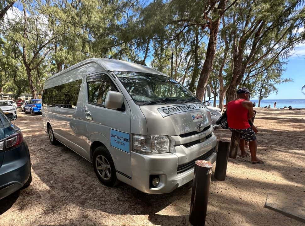 a tourist bus or van parked at the beach at flic en flac in Mauritius