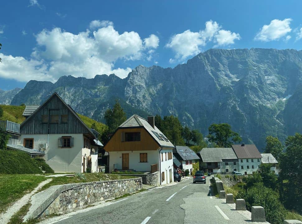 houses set along the the street with incredible mountain range in the background, just north of Bovec Slovenia