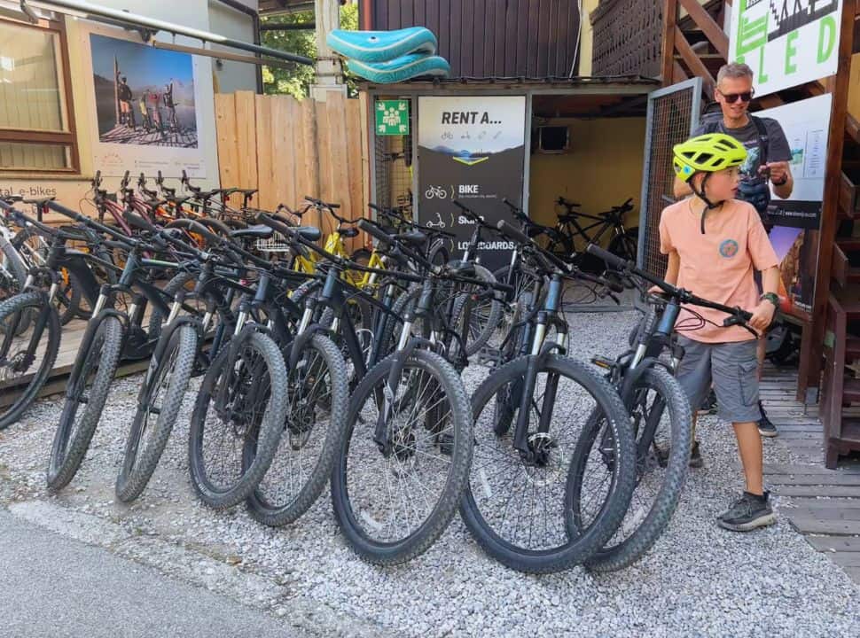 father and son getting their rental mountain bike from the rental shop in Bled