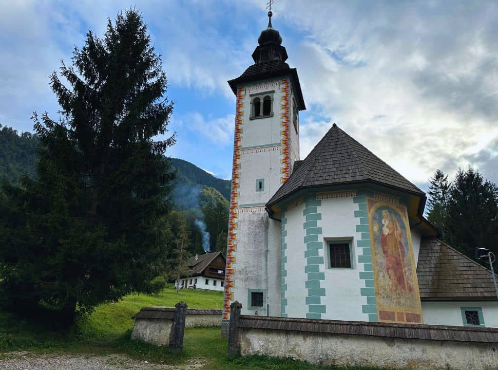 traditional church with beautiful decorations and a religious mural, in the back smoke is coming out of an chimney