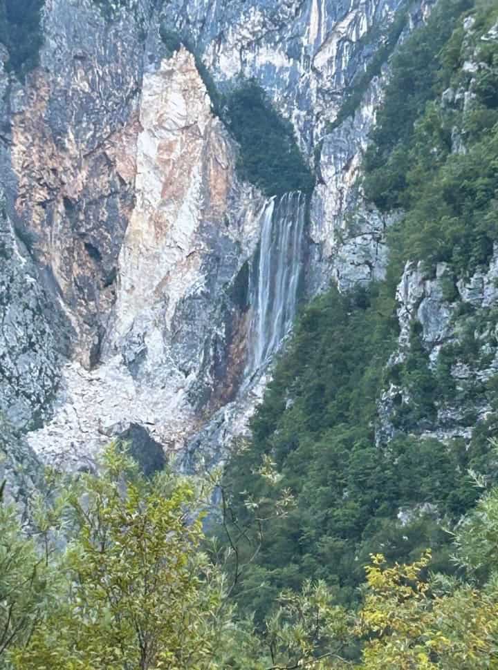 waterfall tucked within the mountain rocks near Bovec Slovenia