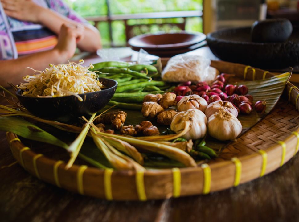 a tray with ingredients for a cooking class such as garlic, union, ginger, bean sprouts and more