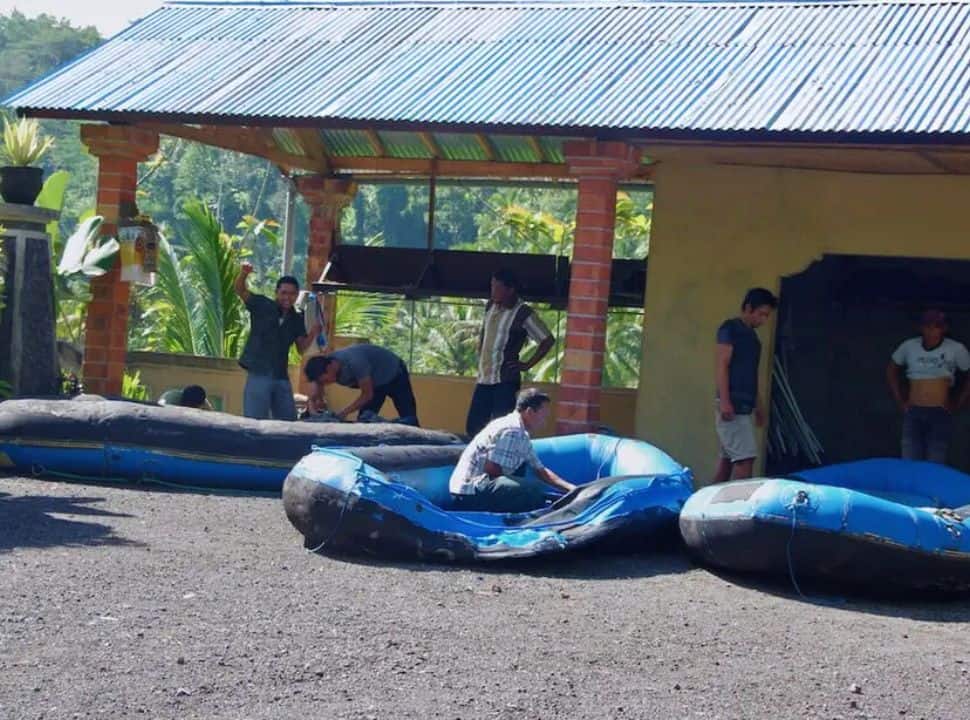 men preparing the boats for a rafting tour nearby Sidemen. 