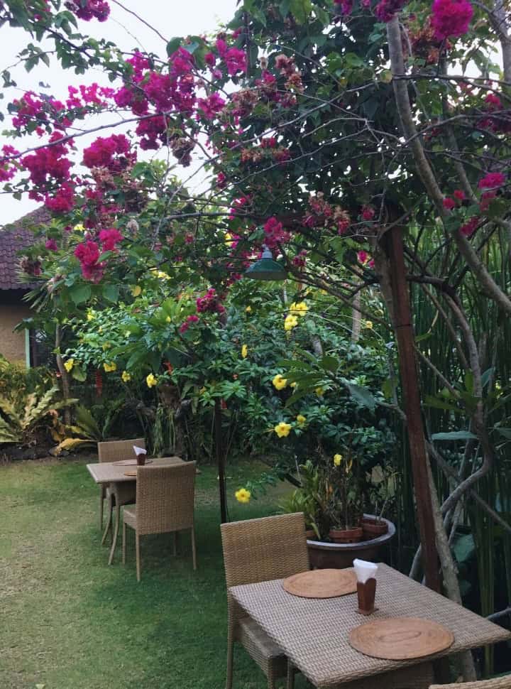 tables set in a colorful tropical garden in Sidemen Bali