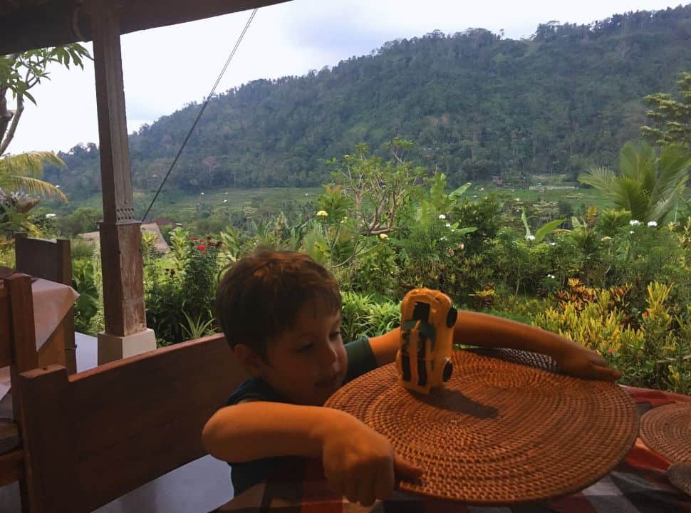 beautiful view of the valley and hills from the terrace of a restaurant, a boy is balancing his toy car on the table in one of the Sidemen restaurants