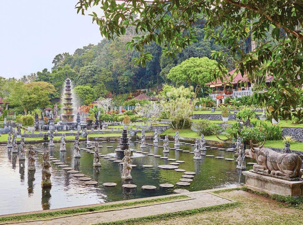 water temple in Tirta Gangga Bali, with several pools decorated with statues