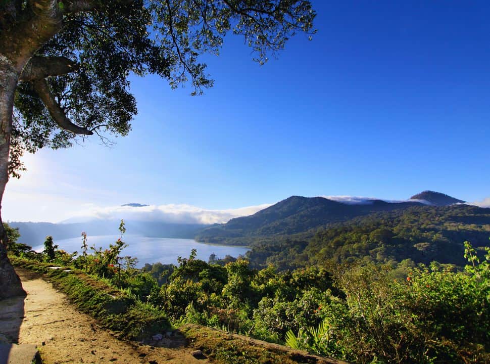 clear view of the lake Tamblingan, with mountains in the backdrop nearby Munduk Bali