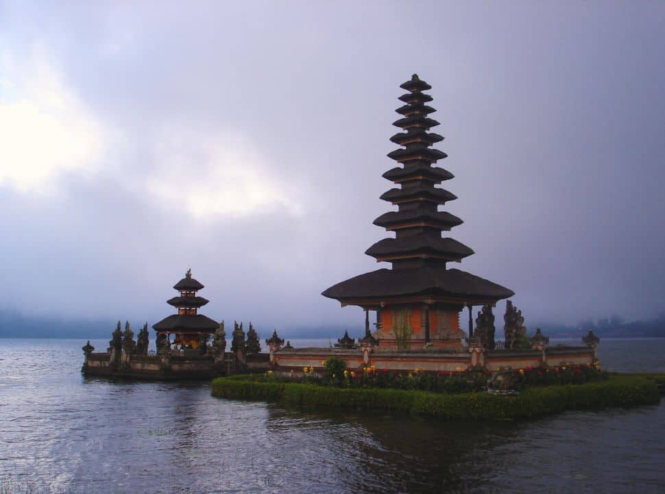 Balinese temple set on the water of a lake and surrounded by misty clouds nearby Bedugul, a mountain village in the central part of Bali