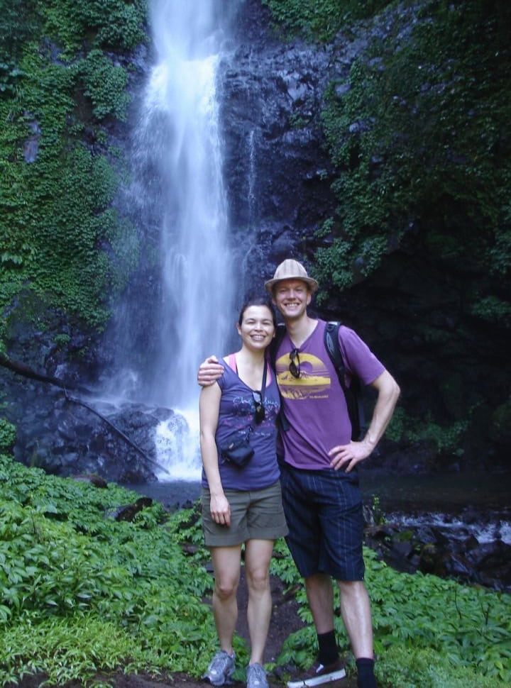 couple posing in front of a  popular waterfall in Munduk Bali