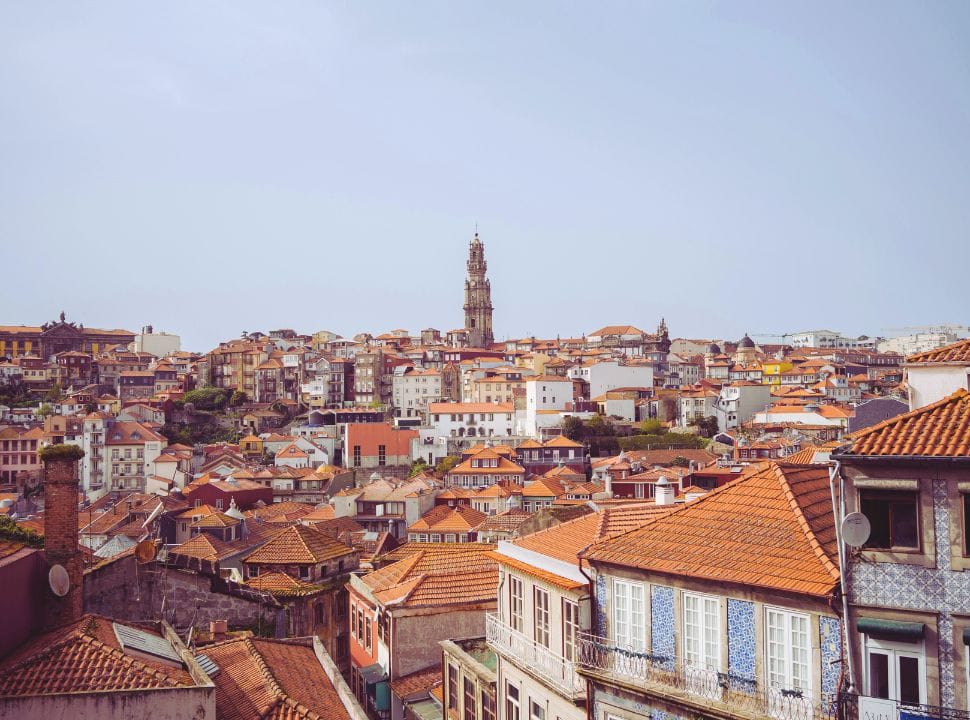 view over the rooftops of Porto Portugal with in the center a tall church tower
