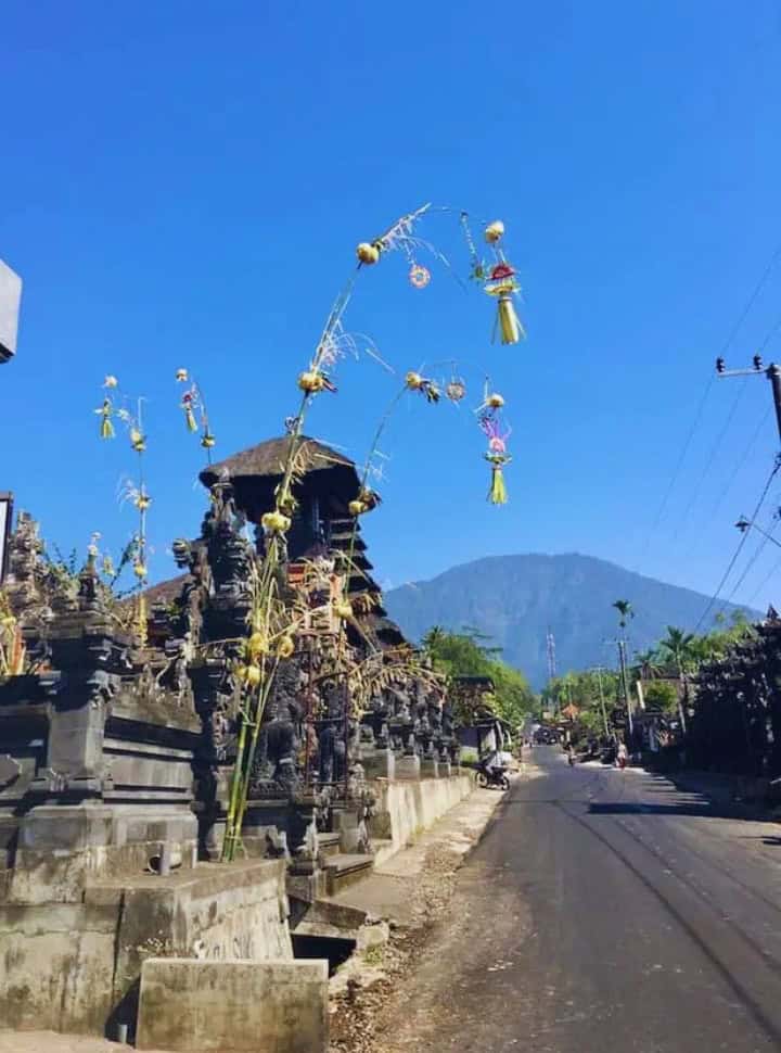 decorated main road in Wongayagede with Mount Batukaru in the distance
