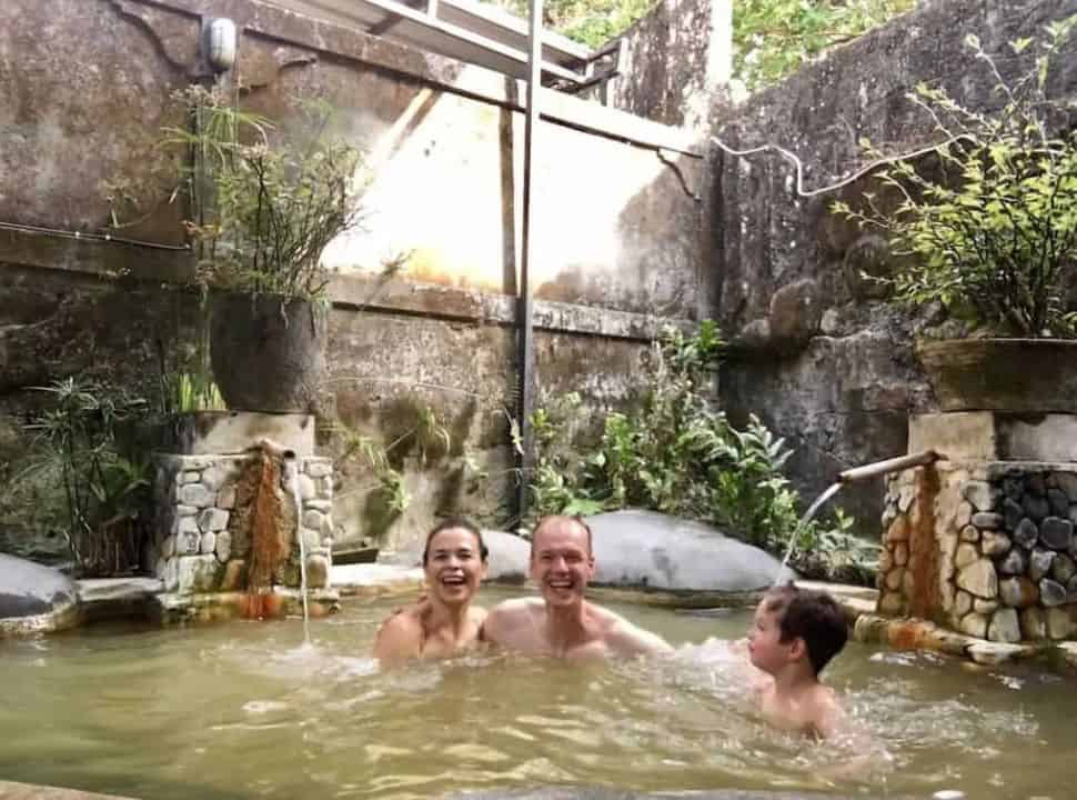 family of three enjoying at the private hot springs at Penatahan near Batukaru