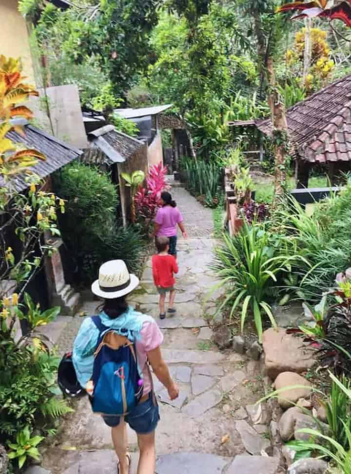 mother and son following a lady showing them the way to the private hot springs in Penatahan