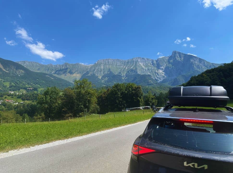 car parked along the road with view of the mountain range in slovenia