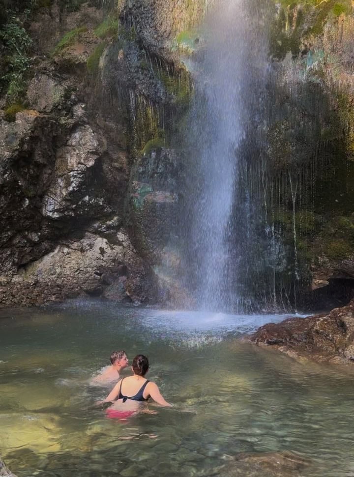 mother and son swimming in the waterfall pool in Slovenia