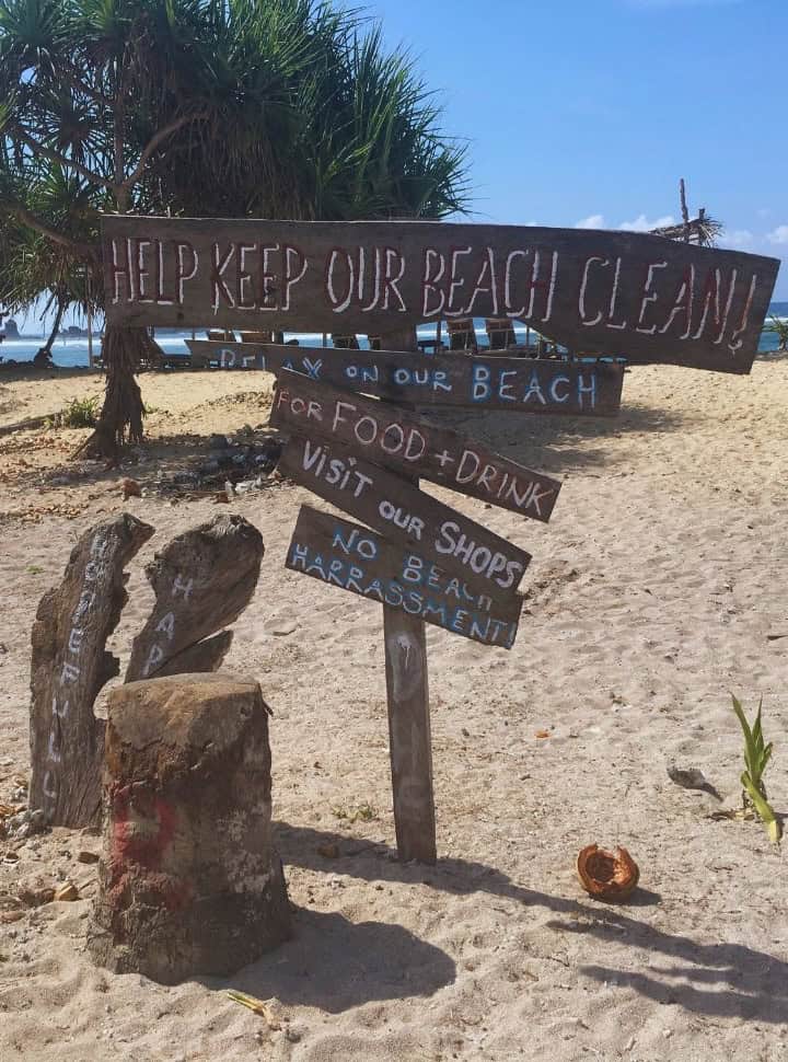 sign on a Lombok beach with the text: help keep our beach clean, relax on our beach, for food and drink, visit our shops, no beach harrasment