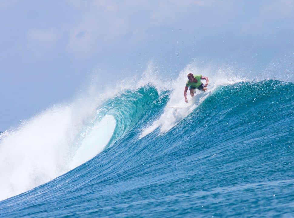 surfer catching a high wave at Mawi Lombok beach