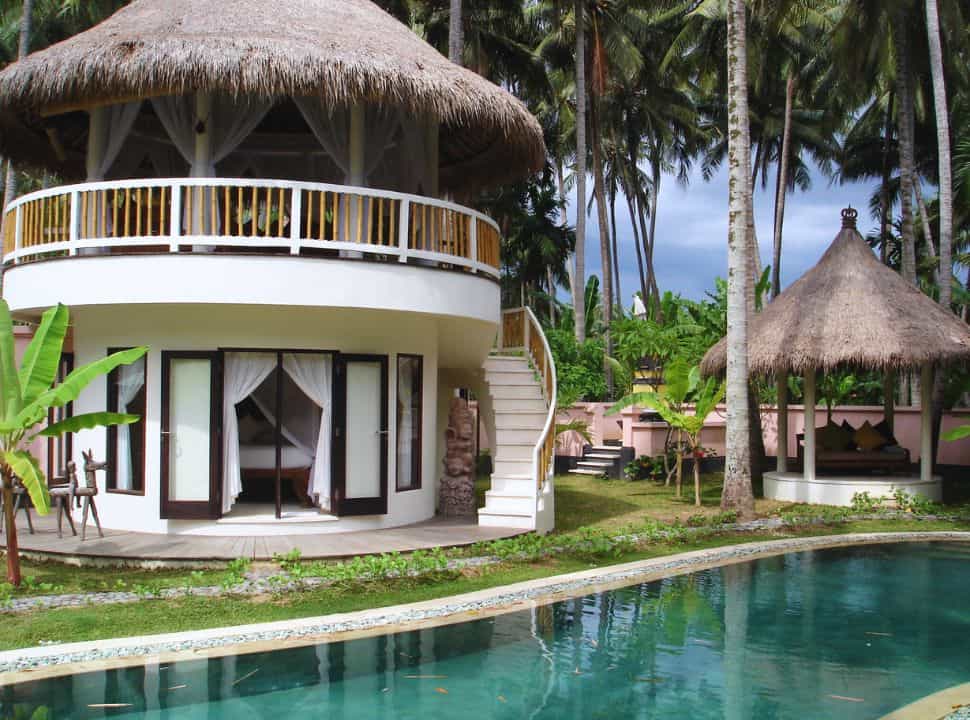 a private villa with pool set within a field of coconuts, a gazebo is located next to it in Candidasa Bali