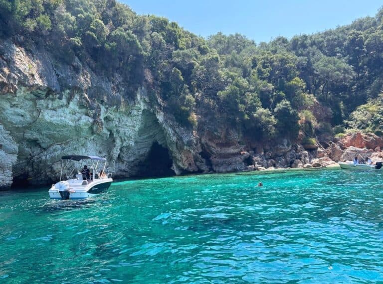 small boat nearby a sea cave at the coast of Paleokastritsa Corfu