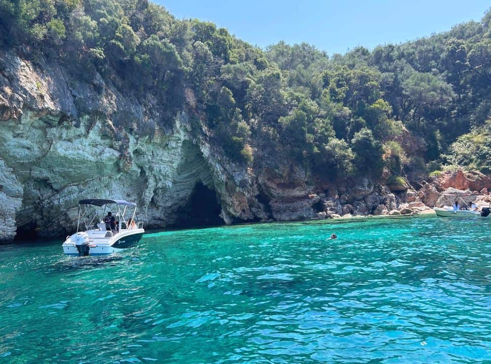 small boat nearby a sea cave at the coast of Paleokastritsa Corfu