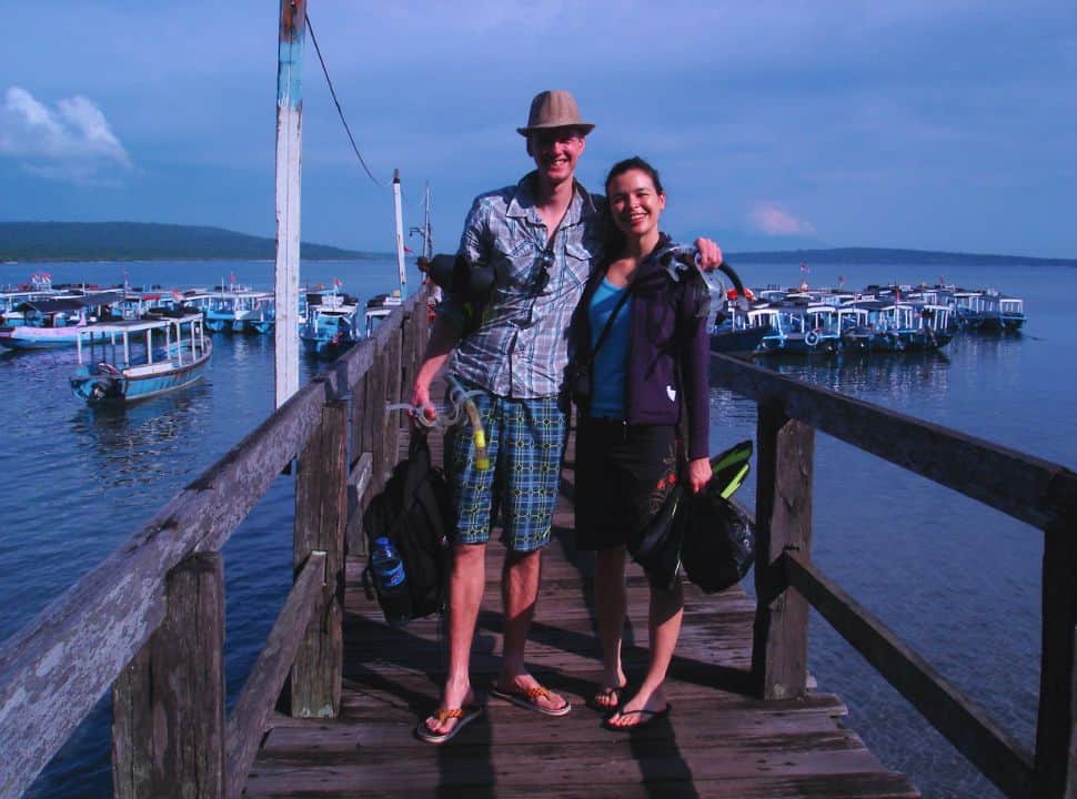 couple posing with their snorkeling gear at a jetty nearby Menjangan island north Bali