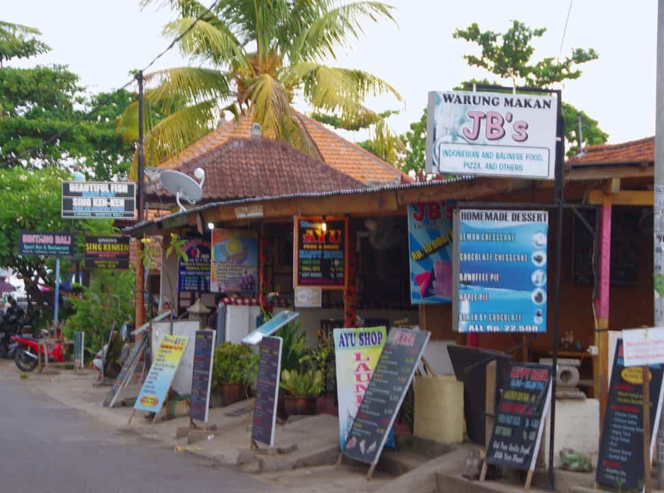 row of little restaurants set along a small street at Lovina Bali