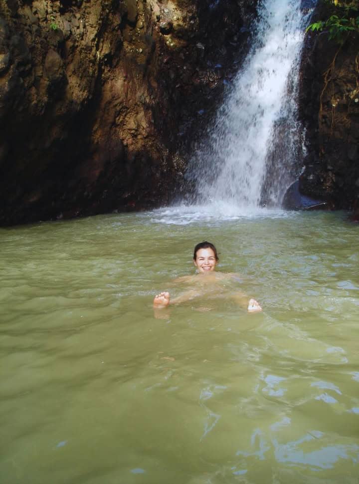 woman enjoying a swim in a waterfall pool closest to Lovina
