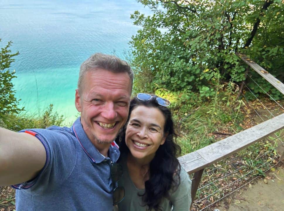 couple posing for a selfie with view on the stunning turquoise blue Adriatic ocean in Slovenia where the beaches are good