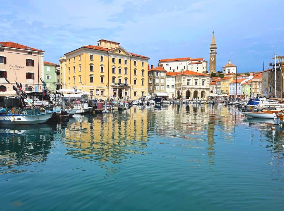 view over the harbor of Piran town in Slovenia with its colorful buildings and prominent church tower